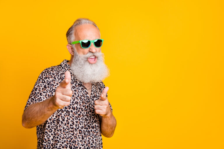 Portrait of funky old bearded man in eyeglasses eyewear feel cool crazy point at you wearing leopard shirt isolated over yellow background
